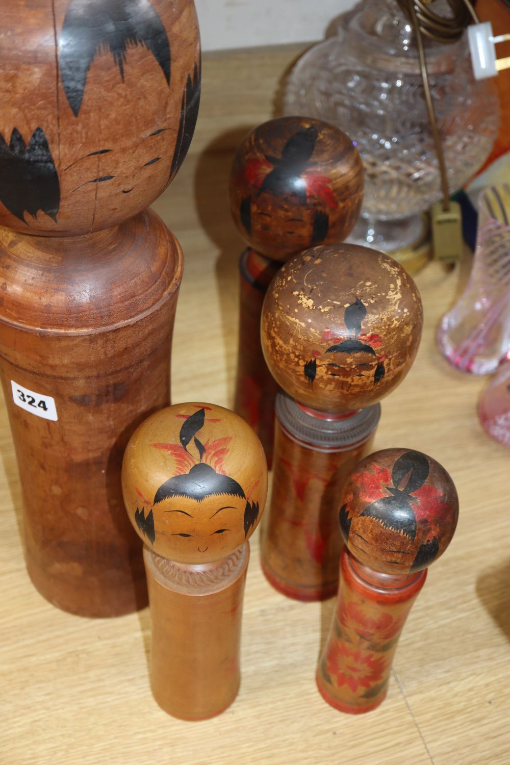 Five Japanese turned wood painted dolls, tallest 49cm